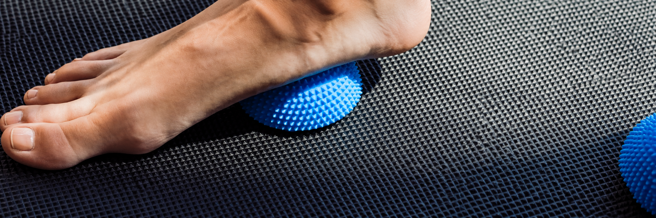 Barefoot Therapy on Blue Spiky Massage Ball